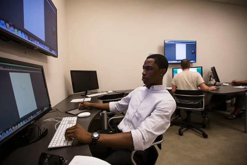 Lee University Communication Arts student working at a digital media studio computer